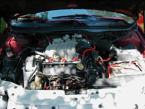 1997 Ford Taurus - Engine bay of a 1997 Ford Taurus, showing the V6 engine and associated components.