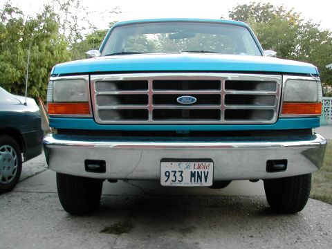 1994 Ford Bronco - Turquoise Ford Bronco with a chrome bumper and a Utah license plate is parked next to another vehicle.
