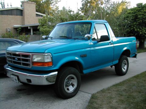 1994 Ford Bronco - This 1994 Ford Bronco is shown in a 3/4 front view, highlighting its iconic body style and bright blue paint.