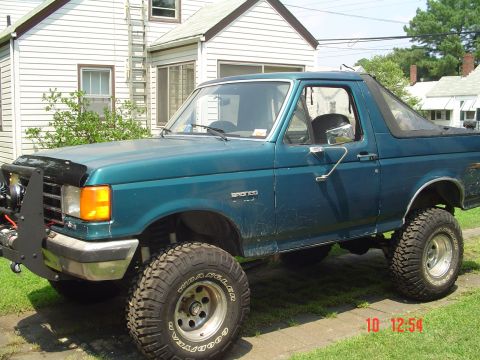 1989 Ford Bronco - This lifted Ford Bronco has a custom front bumper and off-road tires.
