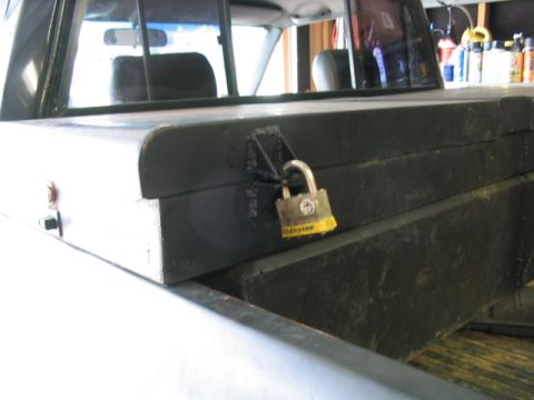 1986 Ford F-150 - Toolbox in a truck bed secured with a Master padlock.