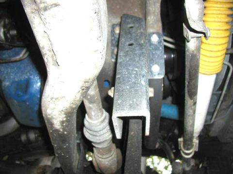 1988 Ford Bronco - Close-up of the undercarriage, showing suspension parts and a yellow shock absorber. The registry claim of a 1988 Ford Bronco is not suppor…