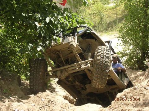 1992 Ford Bronco - A vehicle navigates a challenging off-road course, demonstrating its suspension capabilities.
