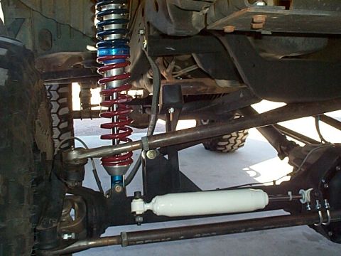 1994 Ford Bronco - Close-up of a vehicle's suspension system, highlighting the coilover shock and steering components.
