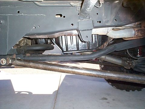 1994 Ford Bronco - Undercarriage view of a vehicle's frame, suspension, and oil pan.
