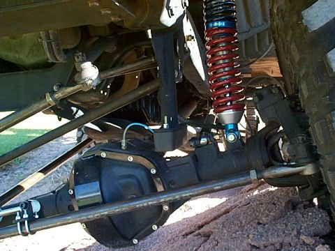 1994 Ford Bronco - Close-up of the undercarriage, highlighting the suspension components and differential, with visible text from Supermotors.net.