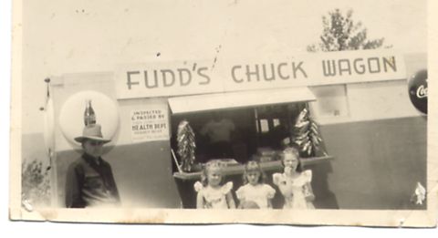 1995 Ford Bronco - Fudd's Chuck Wagon served food, with a man and children posing for a photo.
