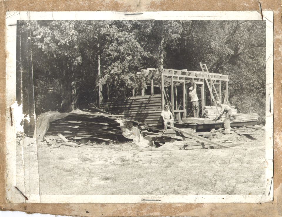 Construction scene with workers building a wooden structure
