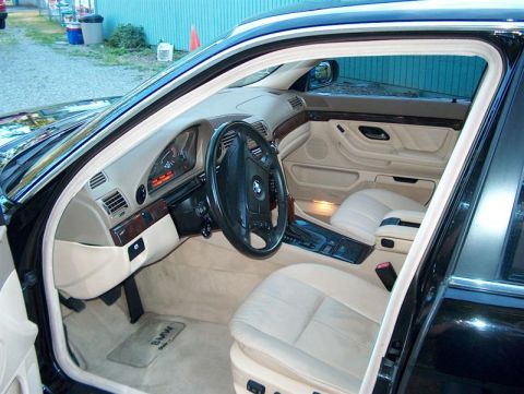 1999 BMW 7 Series - Interior view of a 1999 BMW 7 Series, highlighting its beige leather seats and dashboard details.