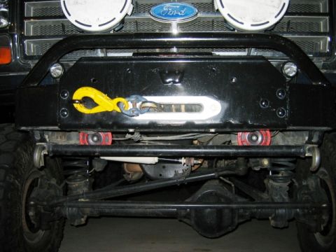1985 Ford Bronco - Front view of a 1985 Ford Bronco, a winch and a prominent yellow tow hook on the bumper.