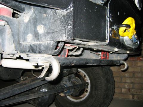 1985 Ford Bronco - Close-up of tow hooks and undercarriage parts on a vehicle.