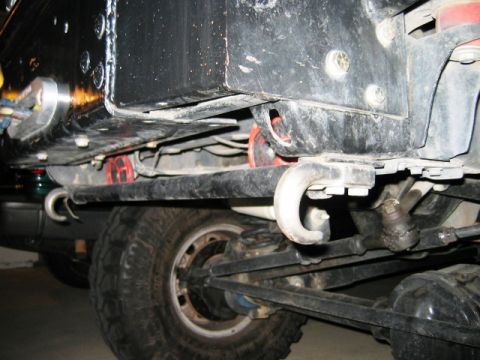 1985 Ford Bronco - The underside of a vehicle reveals its heavy-duty suspension and off-road capabilities.