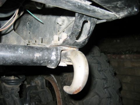1985 Ford Bronco - Close-up view of a vehicle's tow hook and suspension system.