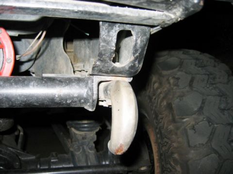 1985 Ford Bronco - Close-up view of a tow hook and a off-road tire, with "SUPERMOTORS.NET" visible at the bottom right.