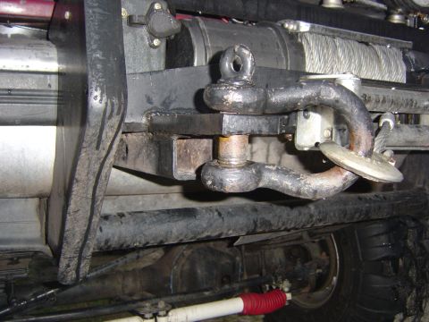 1993 Ford Bronco - Close-up view of a winch and tow hitch assembly, with a red shock absorber visible underneath.