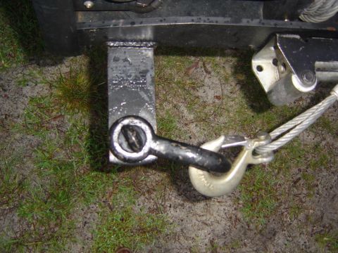 1993 Ford Bronco - Close-up of a tow hitch receiver with a tow hook and cable attached.