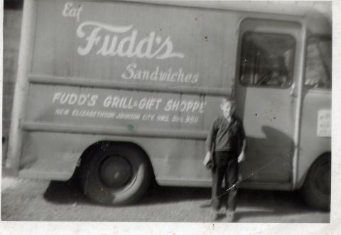 1995 Ford Bronco - A man stands next to a vintage delivery truck advertising Fudd's Sandwiches and Grill & Gift Shoppe.