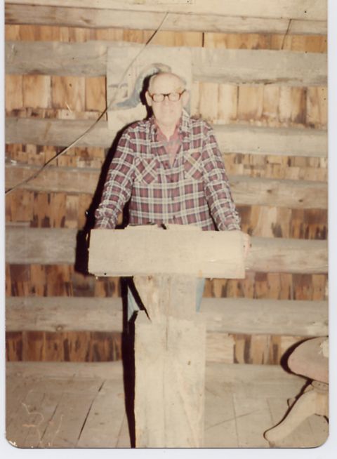 1995 Ford Bronco - An older man stands in front of a wood-paneled wall, holding a piece of lumber.
