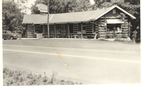 1995 Ford Bronco - Roadside log cabin diner with a vintage car parked outside.