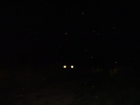 1993 Ford Bronco - Headlights pierce the night, hinting at a vehicle's presence in the dark.