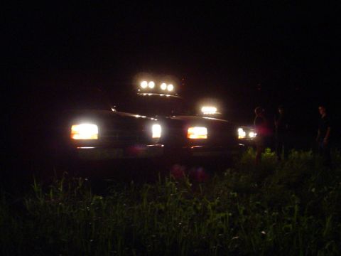 1993 Ford Bronco - Ford Bronco with light bar and auxiliary lights on, parked at night.