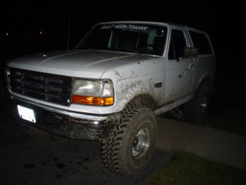 1993 Ford Bronco - White Ford Bronco, likely a 1992 model, covered in mud after off-roading.