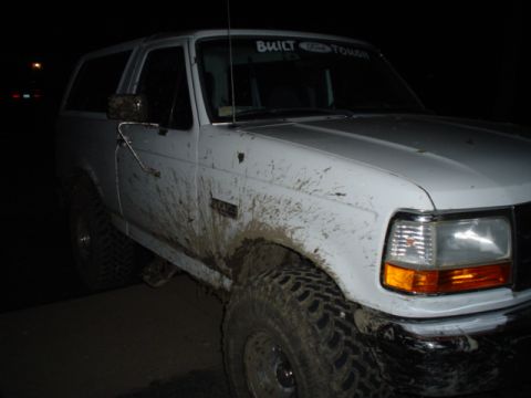 1993 Ford Bronco - This muddy Ford Bronco appears to be from the early to mid-1990s, likely a 1993 model.