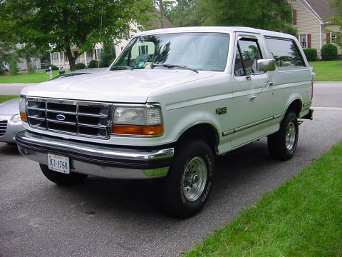 1989 Ford Bronco - White 1989 Ford Bronco parked on a residential driveway.