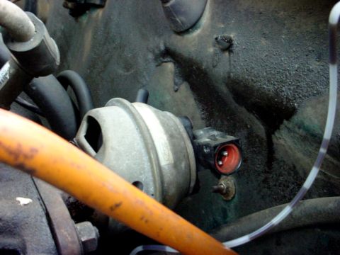 1973 Ford Ranchero - A detailed view of an engine part, showing its connection and surrounding mechanical elements.