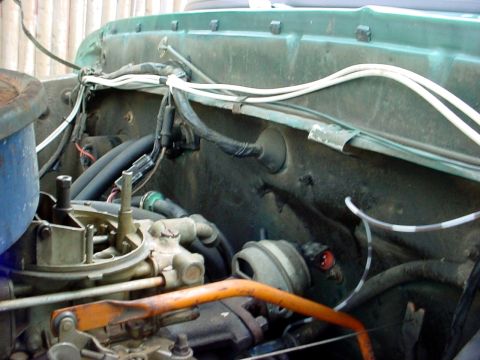 1973 Ford Ranchero - Close-up view of the engine bay, focusing on the carburetor and associated wiring and components.