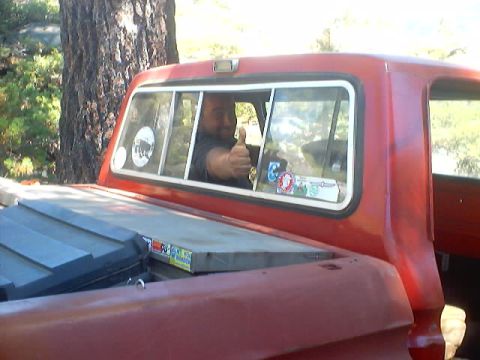1976 Ford F-100 - A man in a red 1976 Ford F-100 gives a thumbs up from the cab.