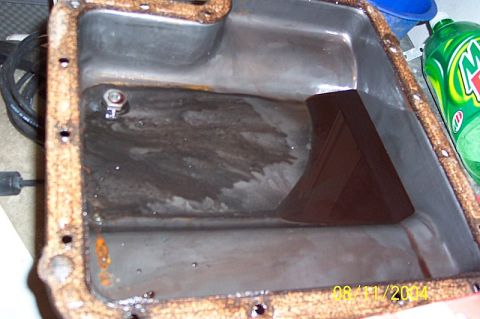 1978 Ford Bronco - This image shows a dirty oil pan, likely removed for maintenance or inspection.