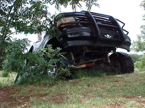 1995 Ford Bronco - This black Ford Bronco appears to be from the early to mid-1990s, with a prominent brush guard and off-road tires.