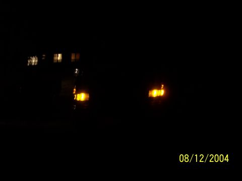 1994 Ford Bronco - The vehicle's front lights are visible in the dark, but the model year cannot be determined.