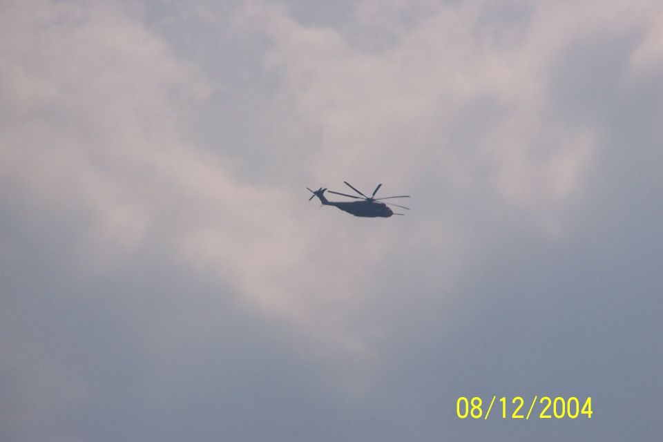 helicopter flying in cloudy sky