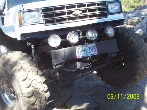 1976 Ford F-100 - A modified truck with oversized tires and auxiliary lights is seen off-road.