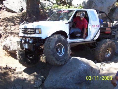 1976 Ford F-100 - A modified pickup truck navigates a rocky off-road course.