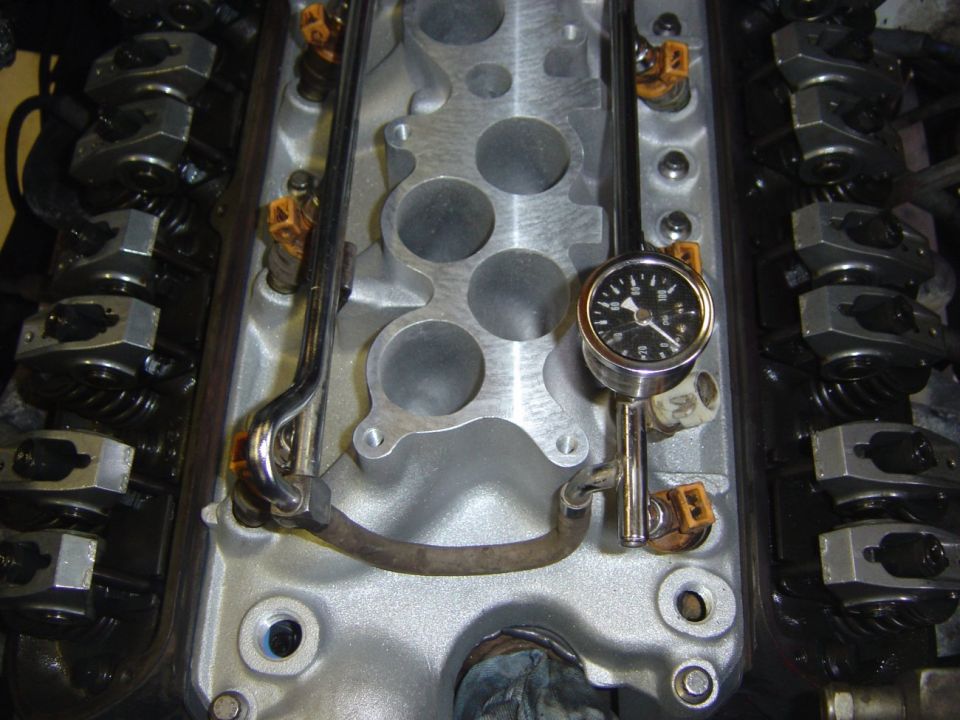 Top-down view of V8 intake manifold, fuel rails, injectors and rocker arms with valve covers off
