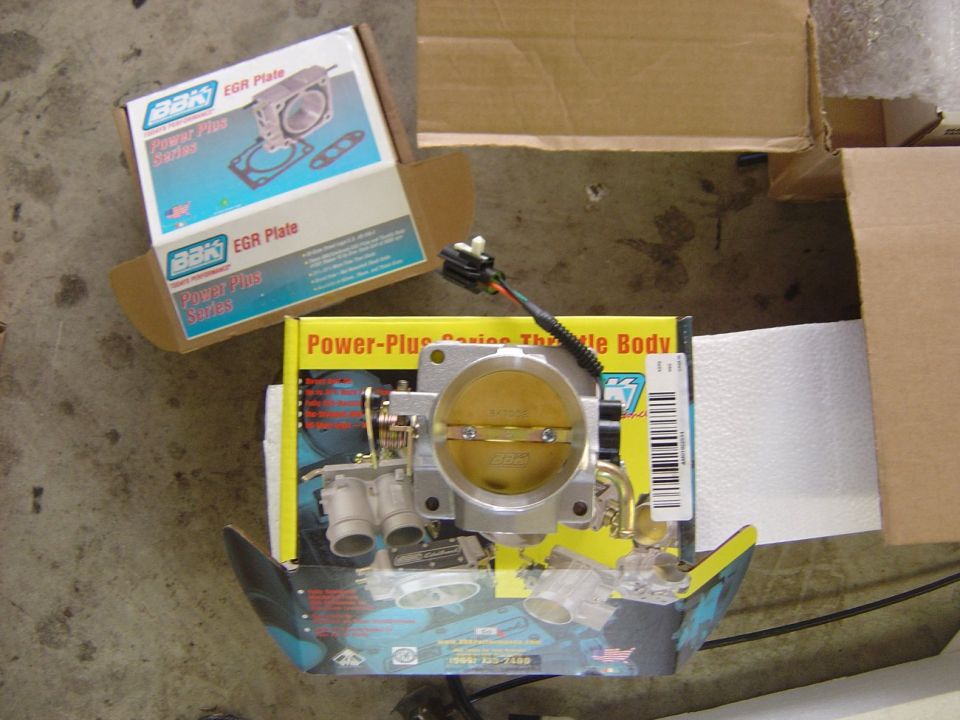 New BBK Power-Plus throttle body and EGR spacer plate in retail boxes on garage floor