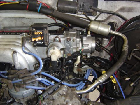 1993 Ford Bronco - Engine-bay detail of an installed Ford 5.0 Liter Cobra upper intake manifold with a black Crane Cams Fireball LX92 ignition module mounted…