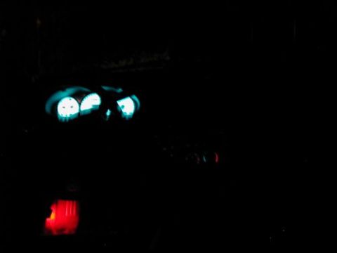 1997 Ford Taurus - The illuminated dashboard gauges and red gear shifter are visible in the dark interior of the vehicle.