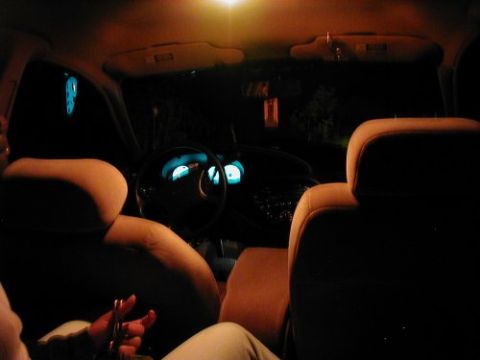 1997 Ford Taurus - Interior view of a 1997 Ford Taurus at night, showing the dashboard and seats.