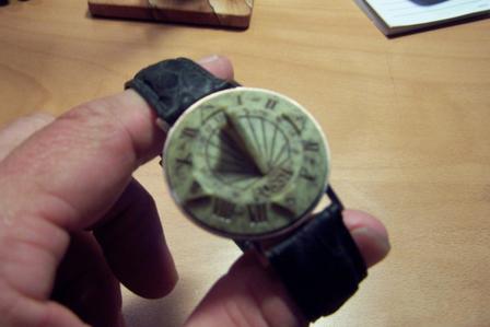 1990 Ford Bronco - A close-up view of a sundial watch being held by a person's hand.
