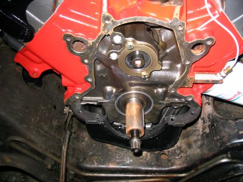 1984 Ford Bronco - Close-up view of an engine's timing chain cover, revealing internal components and mounting hardware.