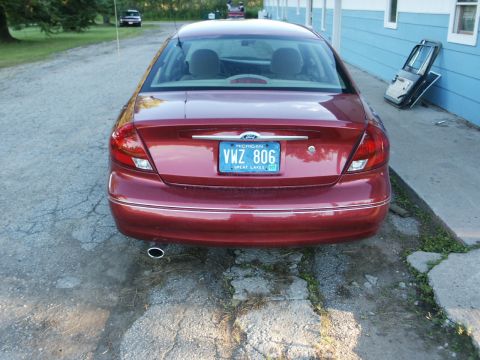2000 Ford Taurus - Rear view of a red 2000 Ford Taurus parked outdoors.