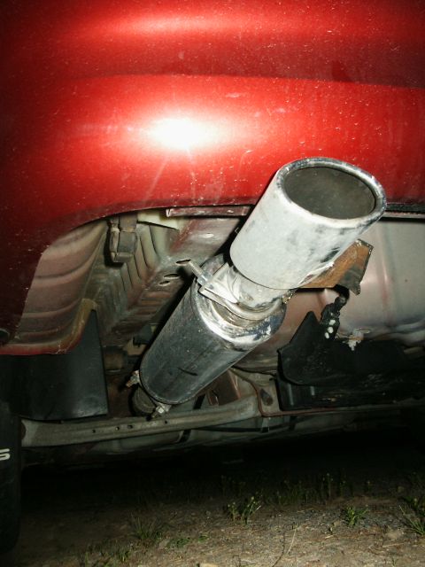 2000 Ford Taurus - Close-up view of a car's exhaust system, showing the muffler and tailpipe.