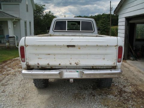 1979 Ford F-150 - Rear view of a white 1979 Ford F-150 pickup truck with a chrome bumper and Illinois license plate.