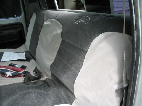 1979 Ford F-150 - The interior of a Ford truck shows the back seat with a "Ford" logo embroidered on the headrest.
