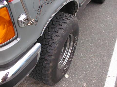 1989 Ford Bronco - This Bronco features aggressive off-road tires and custom pinstriping on the front fender.