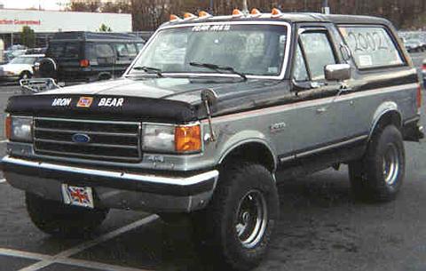 Two-tone gray and black Ford Bronco with "Iron Bear" on the hood and "2002" on the rear window